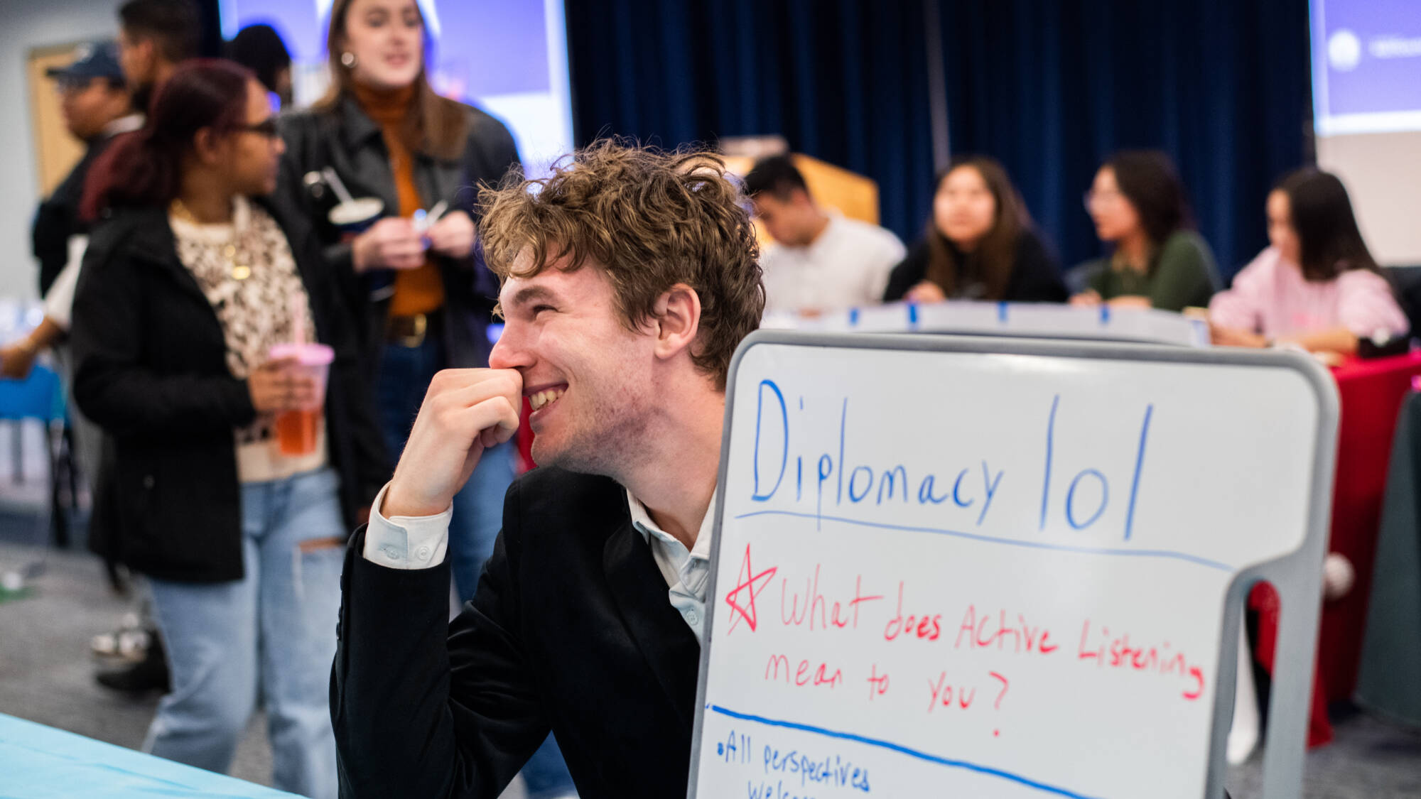 Lincoln White-Day,  an economics and international relations major, talks with students